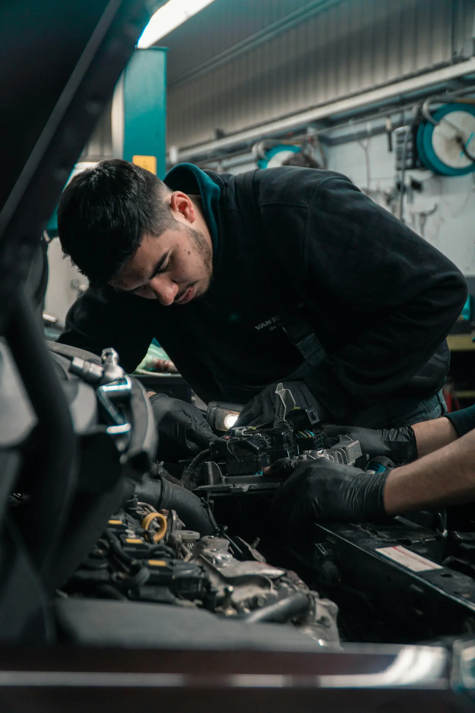 Mechanic working under the hood